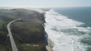DFKSF15_093 - 5K aerial stock footage tilt from Highway 1 and fly over coastal cliffs, Pescadero, California