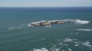 DFKSF15_102 - 5K aerial stock footage of flying by Año Nuevo Island off the coast of California