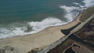 DFKSF15_110 - 5K aerial stock footage flyby the Highway 1 coastal road, revealing a beach, Davenport, California