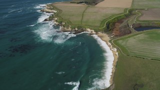 DFKSF15_118 - 5K aerial stock footage of flying away from coastal cliffs, Santa Cruz, California
