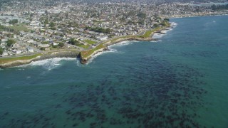 DFKSF15_126 - 5K aerial stock footage of tilting from kelp forests to reveal coastal neighborhoods, Santa Cruz, California