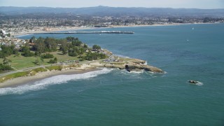 DFKSF15_127 - 5K aerial stock footage of tilt from kelp forests to reveal coastal neighborhoods and Santa Cruz Wharf, Santa Cruz, California