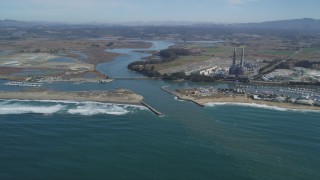 DFKSF15_147 - 5K aerial stock footage of a power plant with smoke stacks near a beach, Moss Landing, California