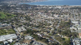 DFKSF15_156 - Aerial stock footage of 5K aerial  video tilt from neighborhood to reveal Monterey Peninsula and Monterey Bay, Monterey, California