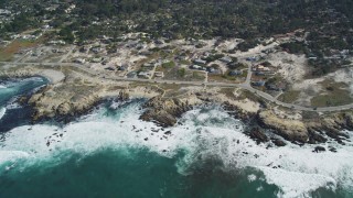 DFKSF16_014 - 5K aerial stock footage of flying by coastal homes on Sunset Drive, Pacific Grove, California