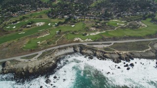 DFKSF16_017 - 5K aerial stock footage of 17 Mile Drive coastal road and golf course near homes in Pebble Beach, California