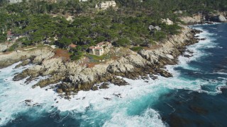 DFKSF16_023 - 5K aerial stock footage of tilting from the ocean to reveal coastal mansions, Pebble Beach, California