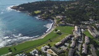DFKSF16_031 - 5K aerial stock footage of a resort hotel and golf course on the shore of Carmel Bay in Pebble Beach, California