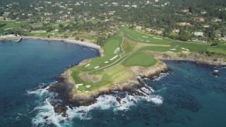 DFKSF16_033 - 5K aerial stock footage tilt from the ocean to reveal a golf course on the coast in Pebble Beach, California