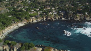 DFKSF16_051 - 5K aerial stock footage of flying by oceanfront homes and a cove, Carmel, California