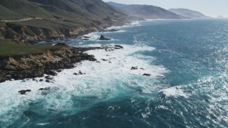 DFKSF16_056 - 5K aerial stock footage of flying over kelp near waves crashing against coastal cliffs, Carmel, California