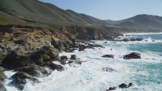 DFKSF16_060 - 5K aerial stock footage of flying over waves crashing into the coastal cliffs and rock formations, Carmel, California