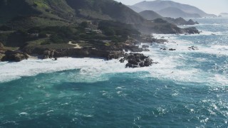 DFKSF16_063 - 5K aerial stock footage of flying by waves crashing against jagged coastline, Carmel, California