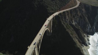 DFKSF16_075 - 5K aerial stock footage of light traffic on the Bixby Creek Bridge above coastal cliffs, Big Sur, California