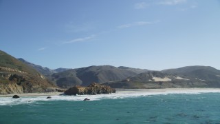 DFKSF16_087 - 5K aerial stock footage of tilting from ocean kelp, reveal coastal rock formations and a beach, Big Sur, California