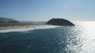 DFKSF16_088 - 5K aerial stock footage of tilting up from ocean revealing Point Sur Light Station, Big Sur, California
