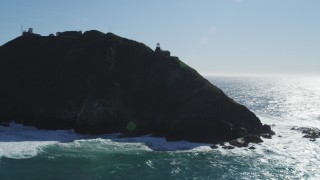 DFKSF16_089 - 5K aerial stock footage tilt from ocean revealing Point Sur Light Station, Big Sur, California