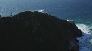 DFKSF16_092 - 5K aerial stock footage of approaching the Point Sur Light Station, above the coastline, Big Sur, California