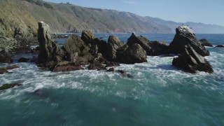 DFKSF16_106 - 5K stock footage aerial video tilt from ocean to reveal rock formation near coastal cliffs, Big Sur, California