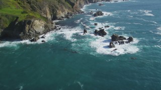 DFKSF16_124 - 5K stock footage aerial video of tilting from the ocean to reveal coastal cliffs, Big Sur, California