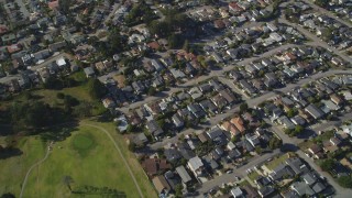 DFKSF16_158 - 5K aerial stock footage of a reverse view of suburban homes, reveal Morro Bay Golf Course, California