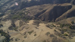 DFKSF17_012 - 5K aerial stock footage of flying away from country roads in the hills, San Luis Obispo County, California