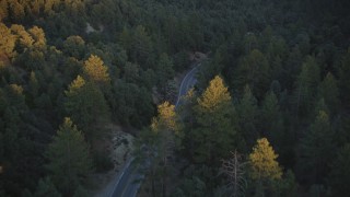 DFKSF17_046 - 5K aerial stock footage of following a road through the forest, Los Padres National Forest, California, sunset