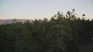 DFKSF17_052 - 5K aerial stock footage of flying low over patches of snow and trees in Los Padres National Forest, California, twilight