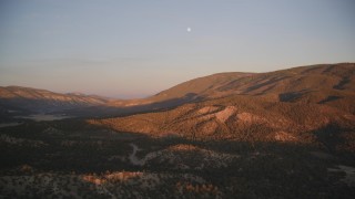 DFKSF17_054 - 5K aerial stock footage of flying by mountains with moon above, Los Padres National Forest, California, sunset