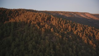 DFKSF17_056 - 5K aerial stock footage of flying by wooded mountain ridge, Los Padres National Forest, California, sunset