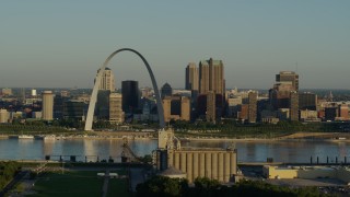 DX0001_000514 - 5.7K aerial stock footage passing by a grain elevator and casino against The Arch and skyline at sunrise, Downtown St. Louis, Missouri