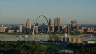 DX0001_000520 - 5.7K aerial stock footage reverse shot of the Arch and skyline seen from a park across the Mississippi River, sunrise, Downtown St. Louis, Missouri