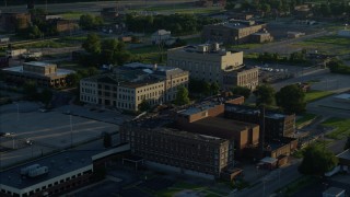 DX0001_000526 - 5.7K aerial stock footage orbiting a federal courthouse and medical center, sunrise, East St. Louis, Illinois