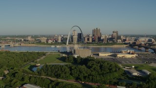 DX0001_000535 - 5.7K aerial stock footage of the Arch and skyline seen from a park in East St. Louis, sunrise, Downtown St. Louis, Missouri