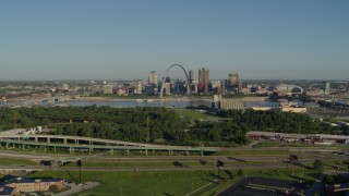 DX0001_000544 - 5.7K aerial stock footage of  a park and freeway with views of skyline and Arch, sunrise, Downtown St. Louis, Missouri