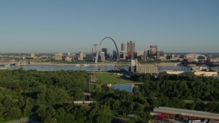 DX0001_000546 - 5.7K aerial stock footage of ascending over freeway toward park in East St. Louis with views of skyline and Arch, sunrise, Downtown St. Louis, Missouri