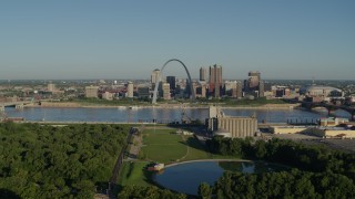 DX0001_000547 - 5.7K aerial stock footage of park looking toward Arch and skyline along the river, sunrise, Downtown St. Louis, Missouri