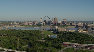DX0001_000548 - 5.7K aerial stock footage reverse over freeway and park showcasing skyline and Arch, sunrise, Downtown St. Louis, Missouri