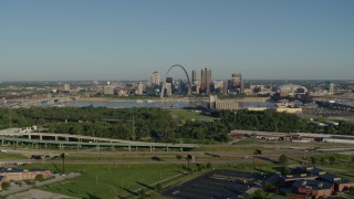 DX0001_000549 - 5.7K aerial stock footage of freeway and park in East St. Louis, looking toward Arch and skyline, sunrise, Downtown St. Louis, Missouri