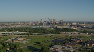 DX0001_000551 - 5.7K aerial stock footage of school and interstate in East St. Lous toward skyline and Arch, sunrise, Downtown St. Louis, Missouri