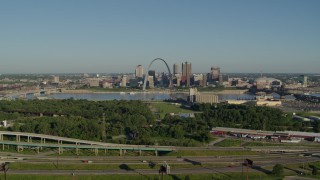 DX0001_000552 - 5.7K aerial stock footage of skyline and Arch from freeway and park in East St. Louis, sunrise, Downtown St. Louis, Missouri