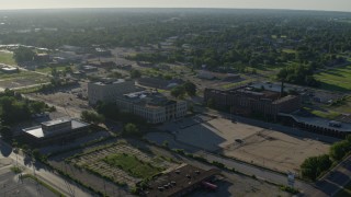 DX0001_000559 - 5.7K aerial stock footage wide angle of a federal courthouse and abandoned hospital, sunrise, East St Louis, Illinois