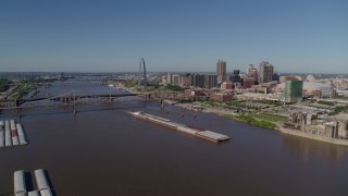 DX0001_000576 - 5.7K aerial stock footage of barges in the river near the Gateway Arch in Downtown St. Louis, Missouri