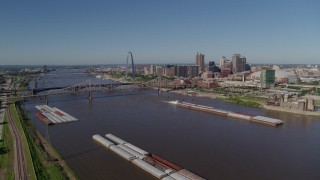 DX0001_000579 - 5.7K aerial stock footage reverse of barges and the Mississippi River near Downtown St. Louis, Missouri