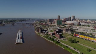DX0001_000583 - 5.7K aerial stock footage flyby riverfront buildings and river barge in Downtown St. Louis, Missouri