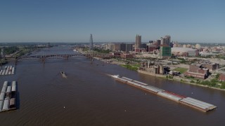DX0001_000584 - 5.7K aerial stock footage of a view of riverfront buildings and barges on the river, Downtown St. Louis, Missouri