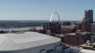 DX0001_000639 - 5.7K aerial stock footage of the Gateway Arch seen while descending by stadium in Downtown St. Louis, Missouri