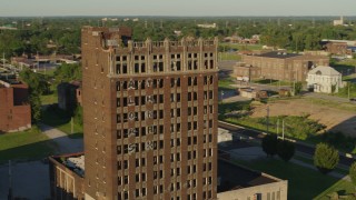 DX0001_000672 - 5.7K aerial stock footage of circling an abandoned brick building at sunset in East St. Louis, Illinois