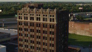 DX0001_000673 - 5.7K aerial stock footage of approaching the abandoned office building at sunset in East St. Louis, Illinois