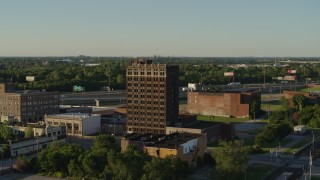 DX0001_000675 - 5.7K aerial stock footage approach an abandoned brick office building at sunset in East St. Louis, Illinois